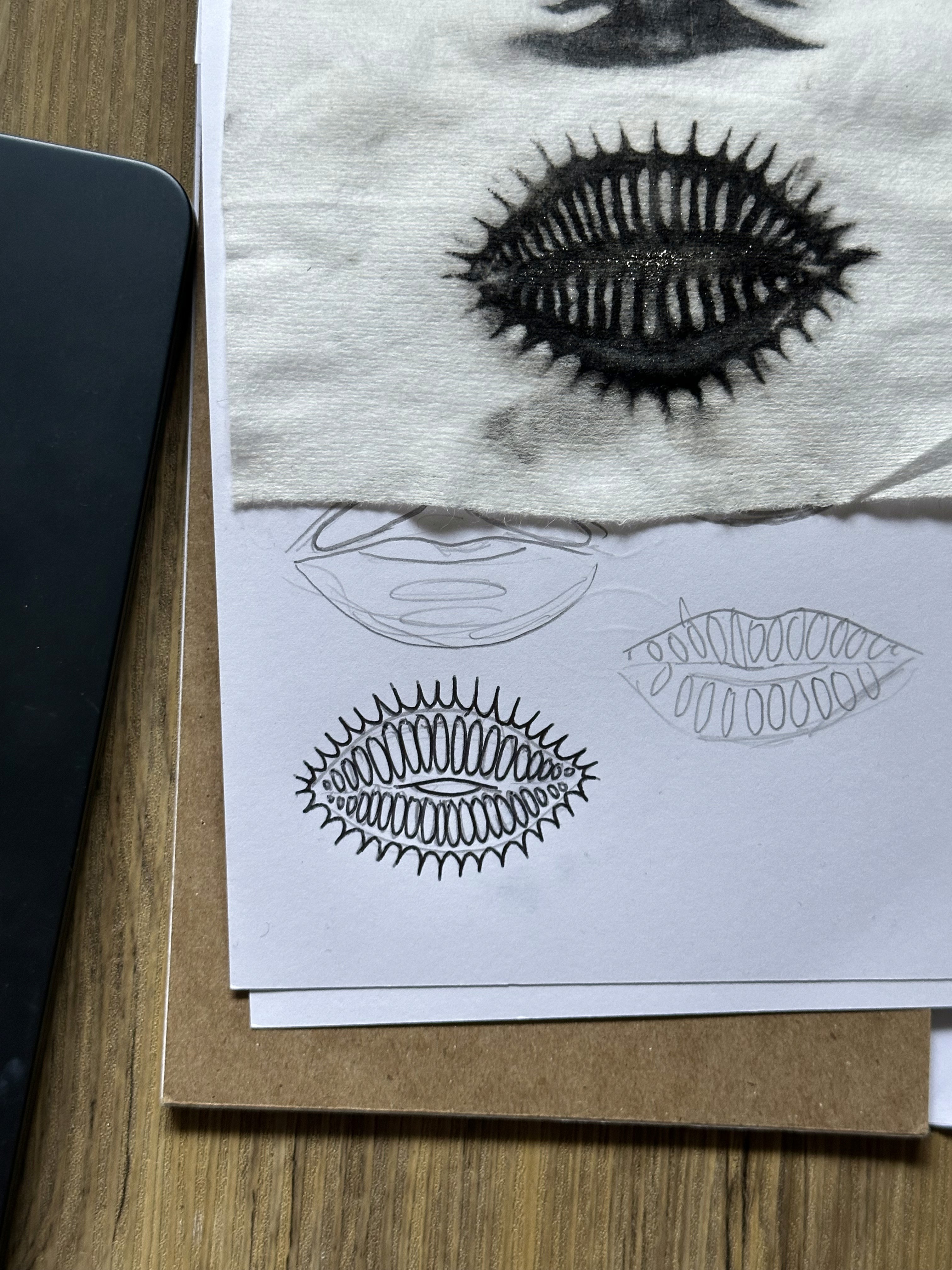 Bo Quinn process board showing a black spiked lip print and pencil studies