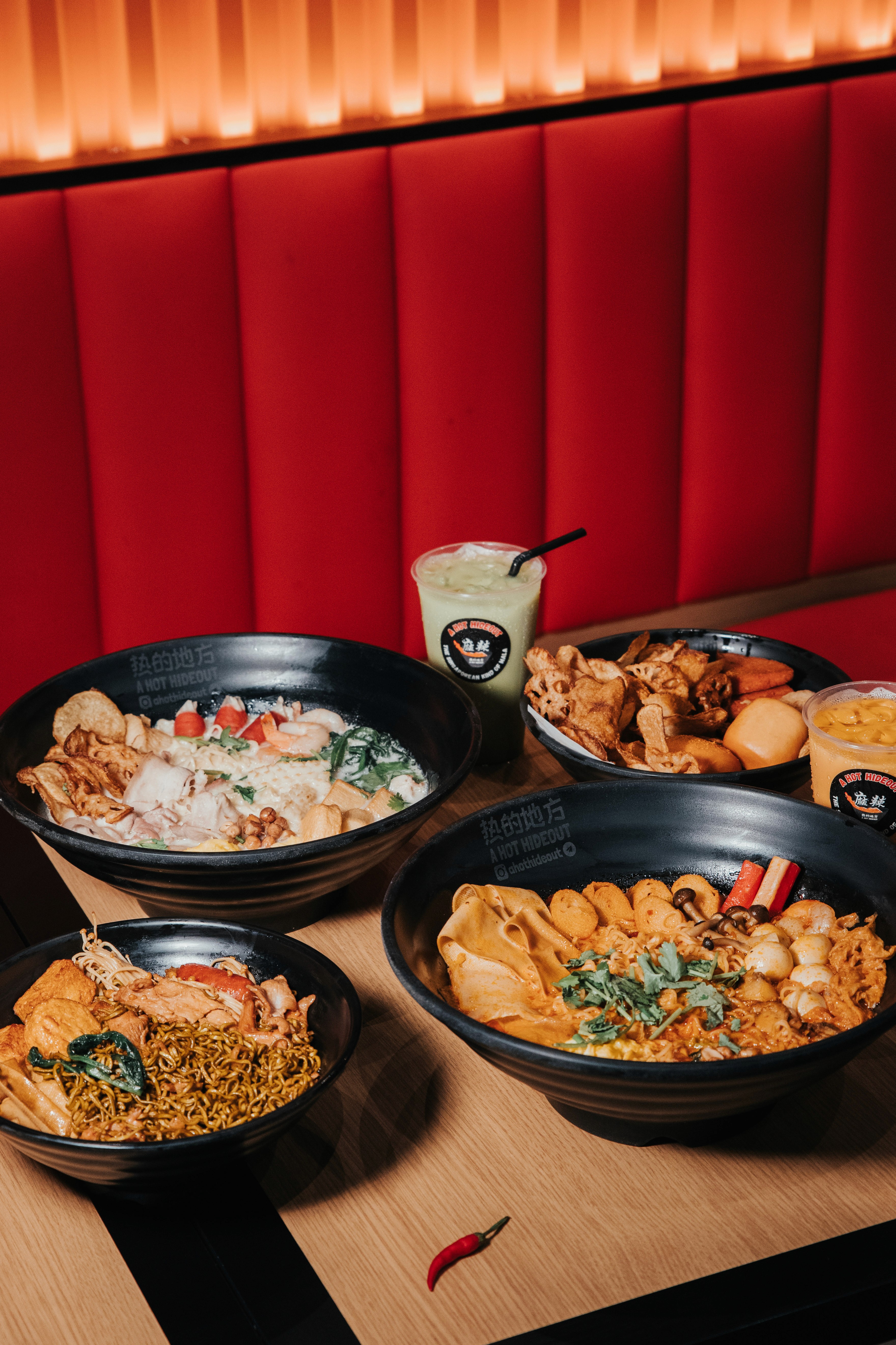 A set of freshly prepared mixed vegetable and noodle bowls in a studio setting.
