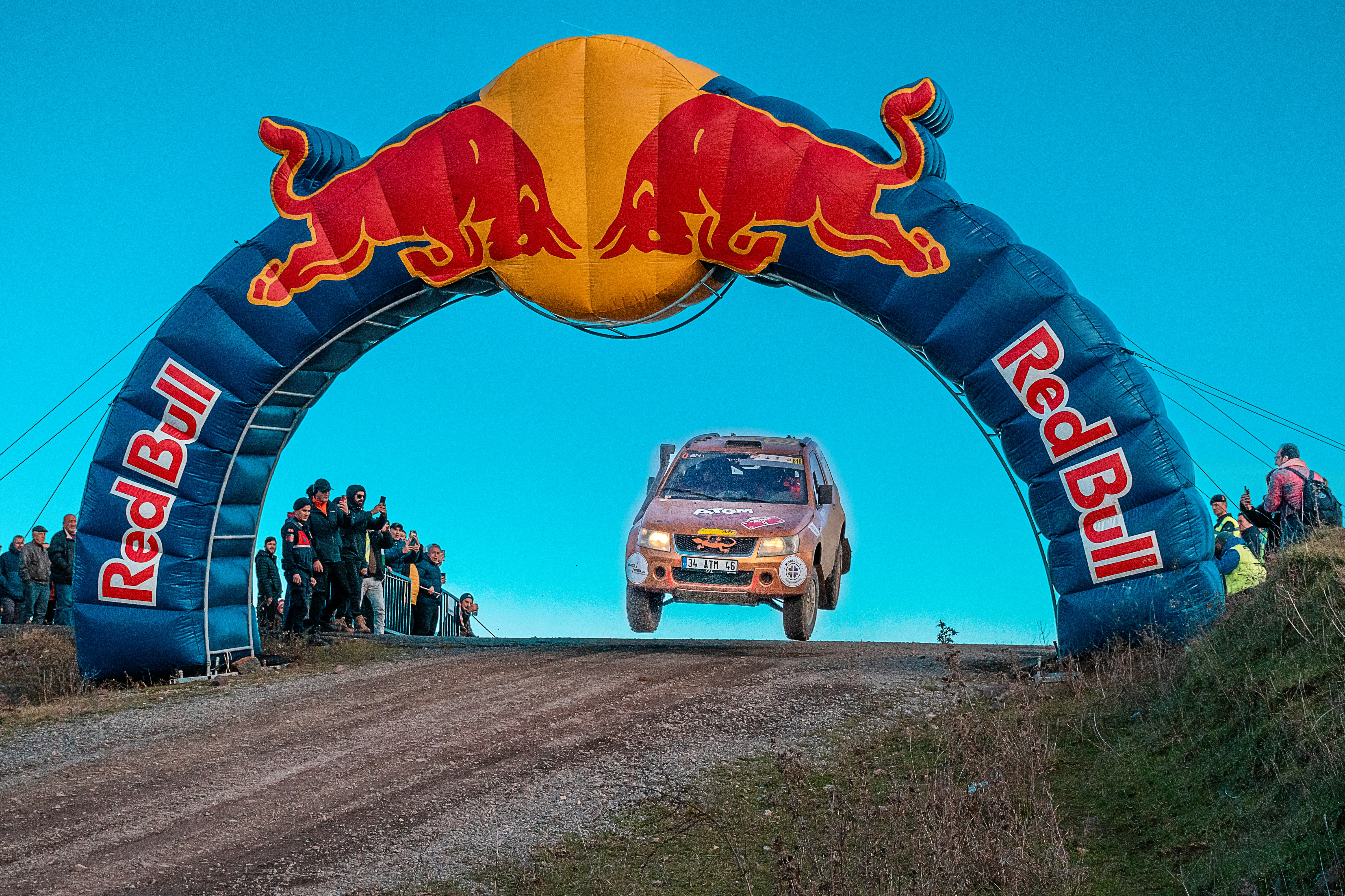 a red bull rally car going through an arch