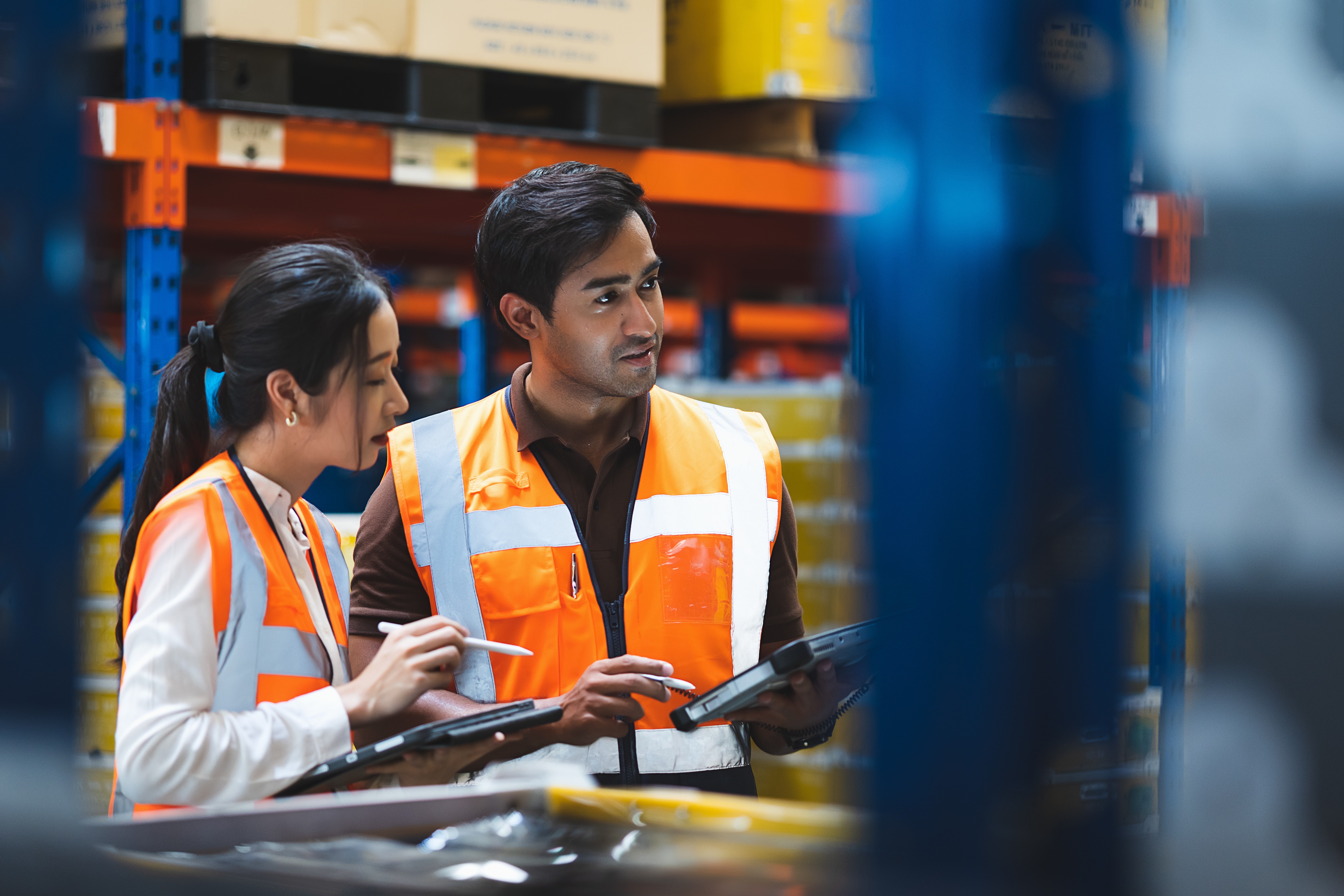warehouse staff with tablets discussing