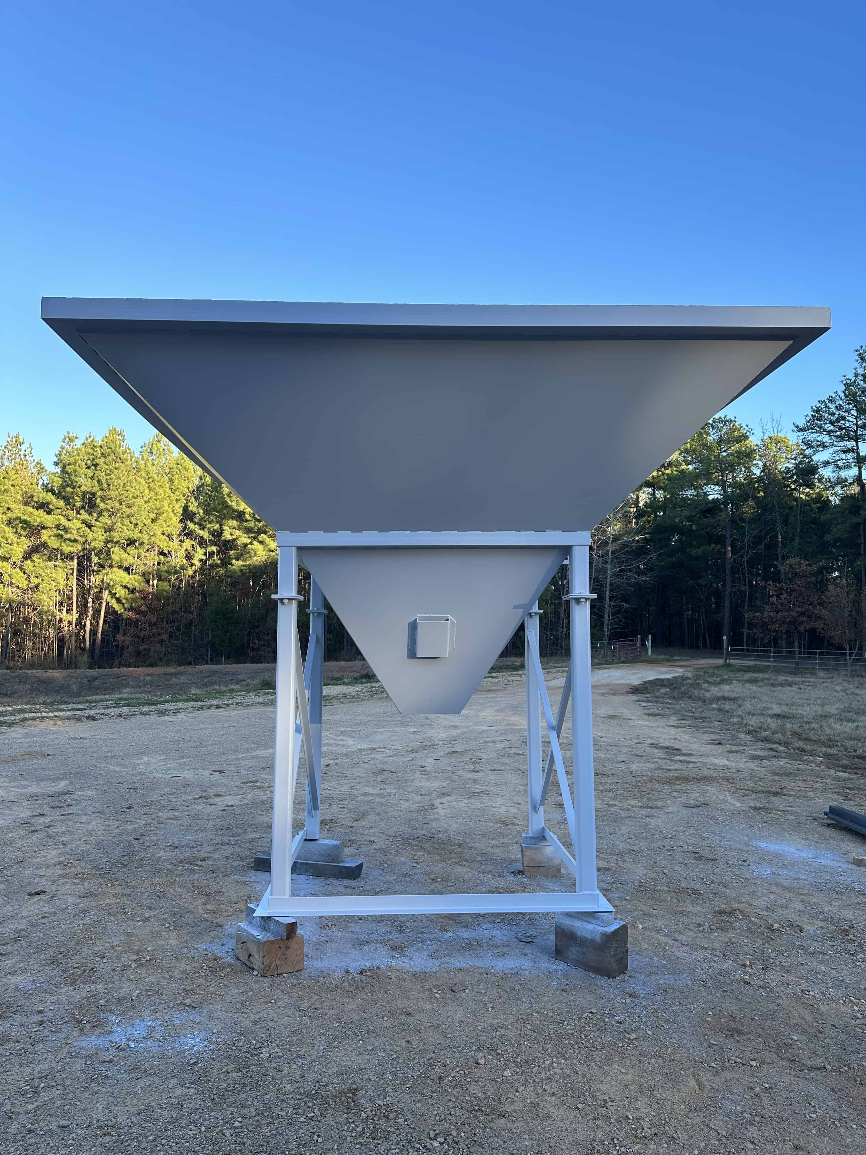 This photo shows a concrete feed hopper we designed and built.  We welded plate, steel tubing, and some angle iron to create the hopper and it's support.  The project was delivered to our client after we finished welding and fabrication in Henderson, Texas.