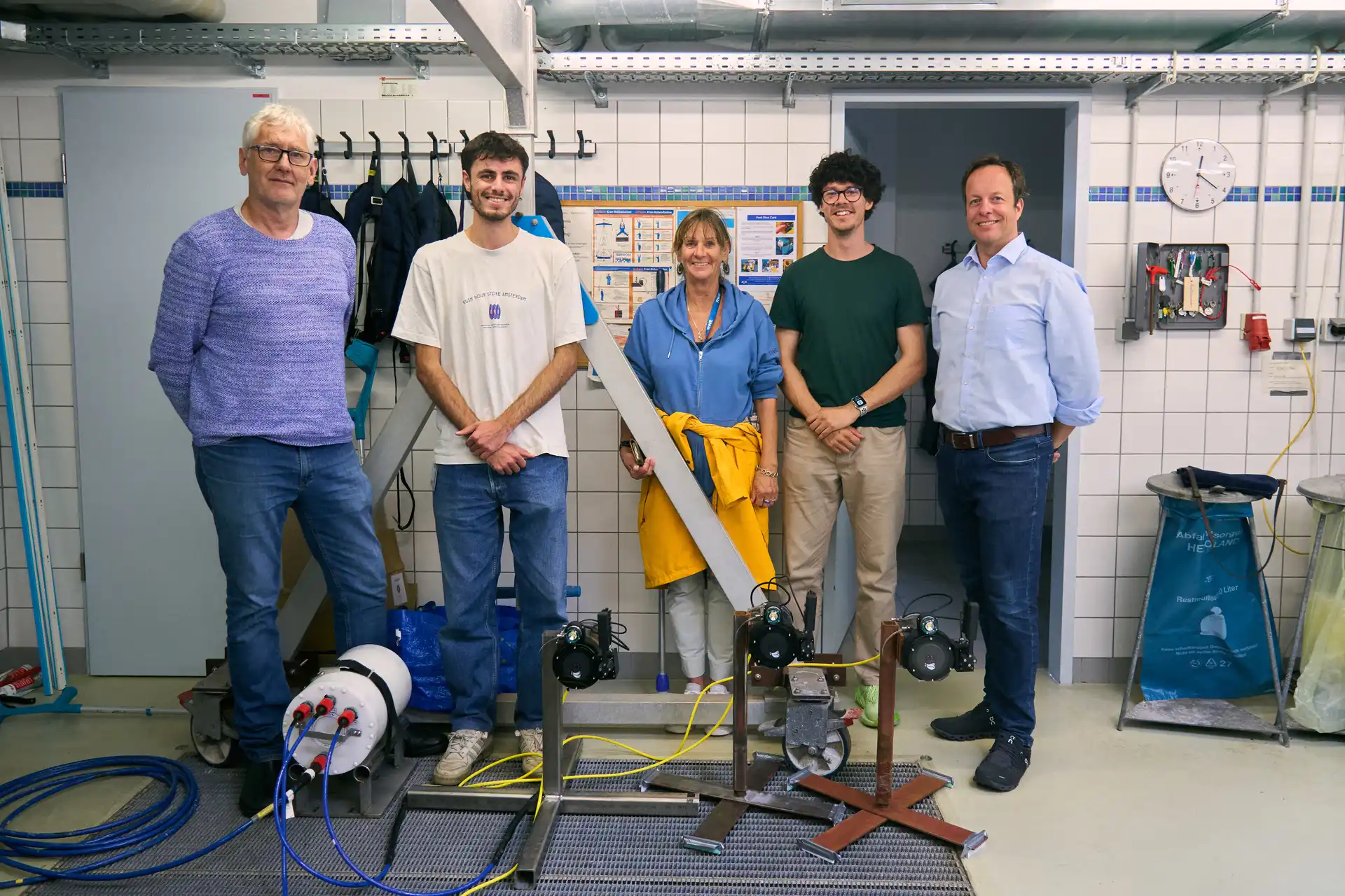 Anemo team with SeaMe Scientists in testing facility standing next to test Anemo Cameras 