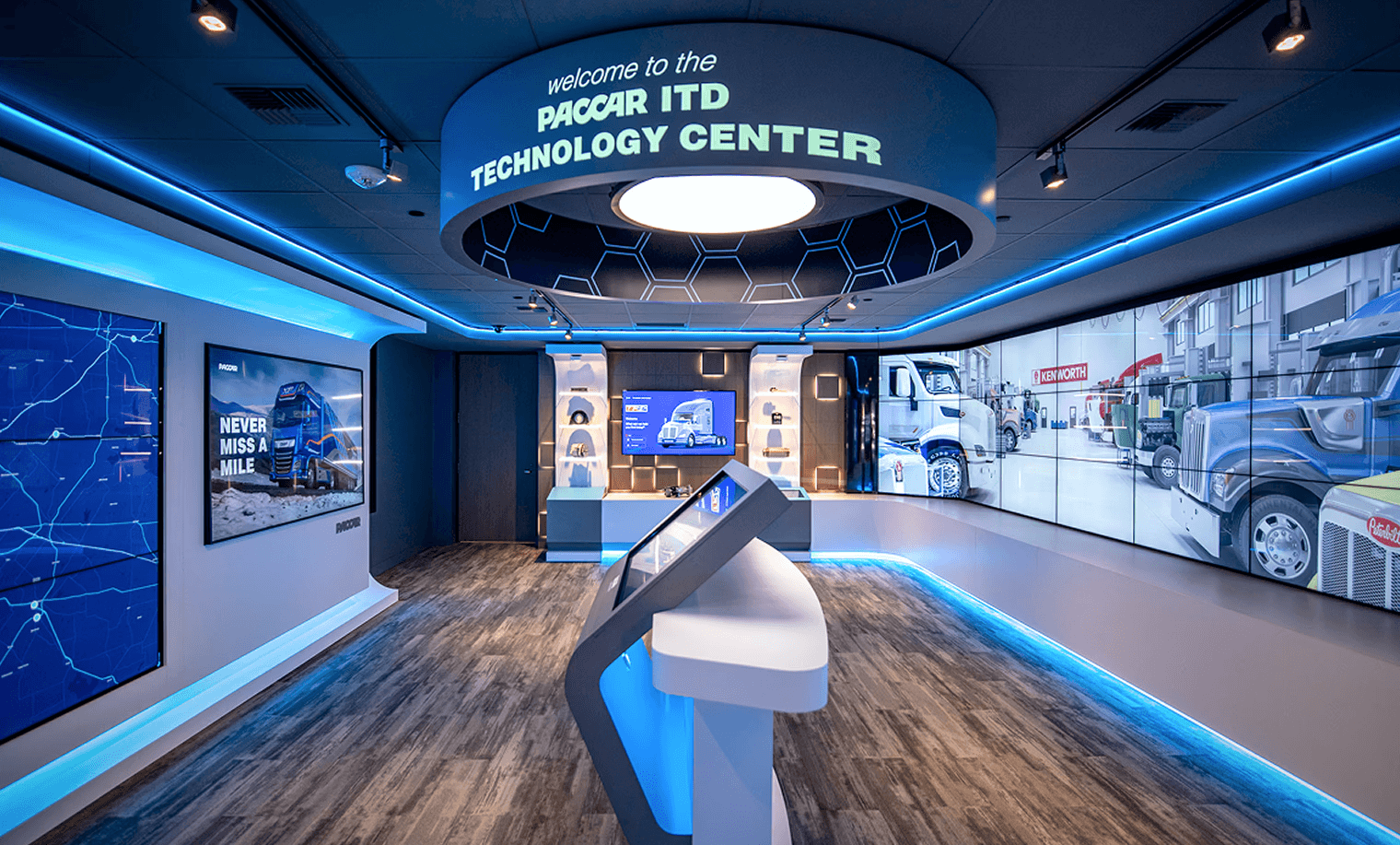 The PACCAR experience kiosk with interactive display and floor to ceiling video screens