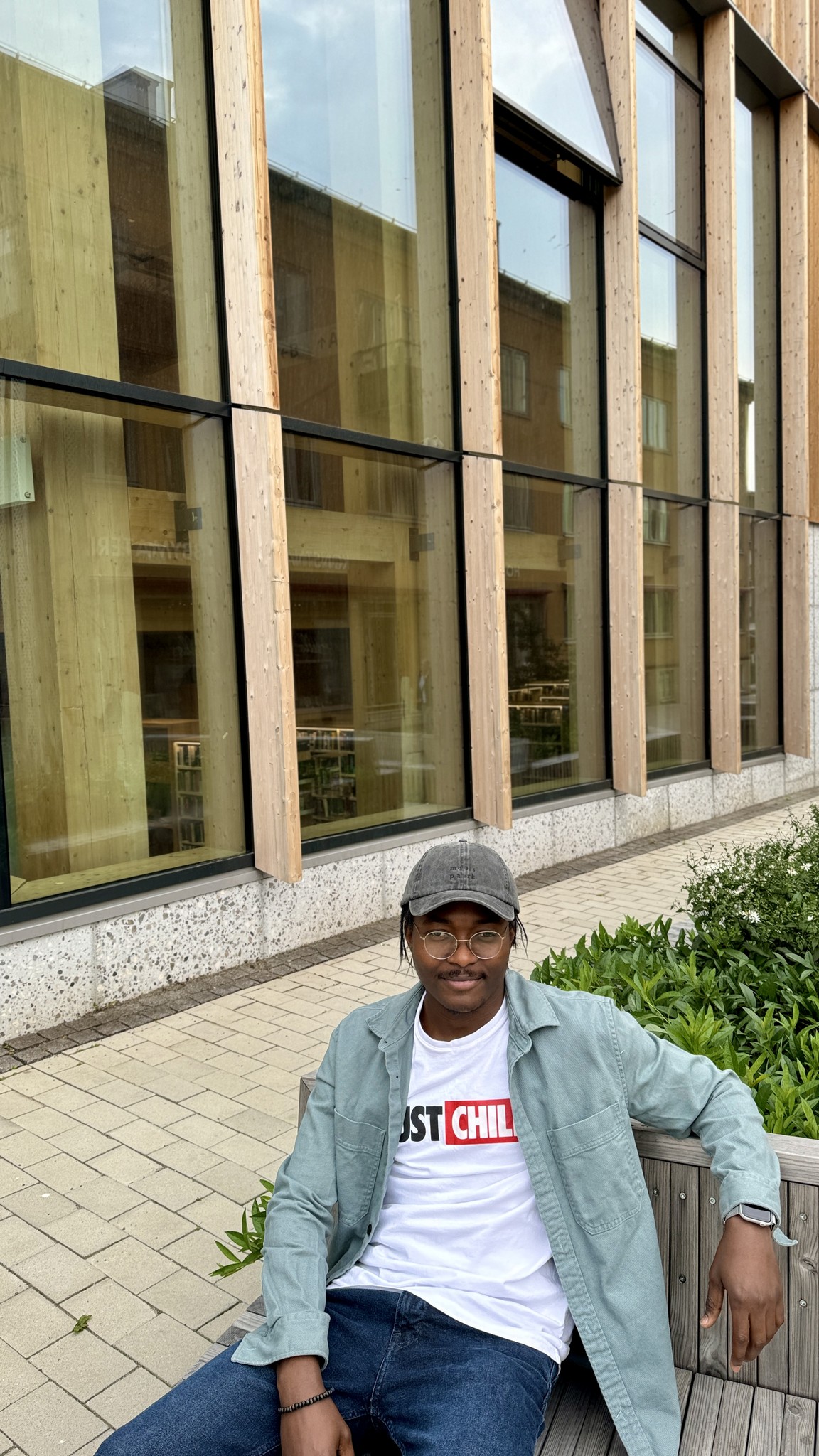 Emmanuel sitting and wearing a baseball cap