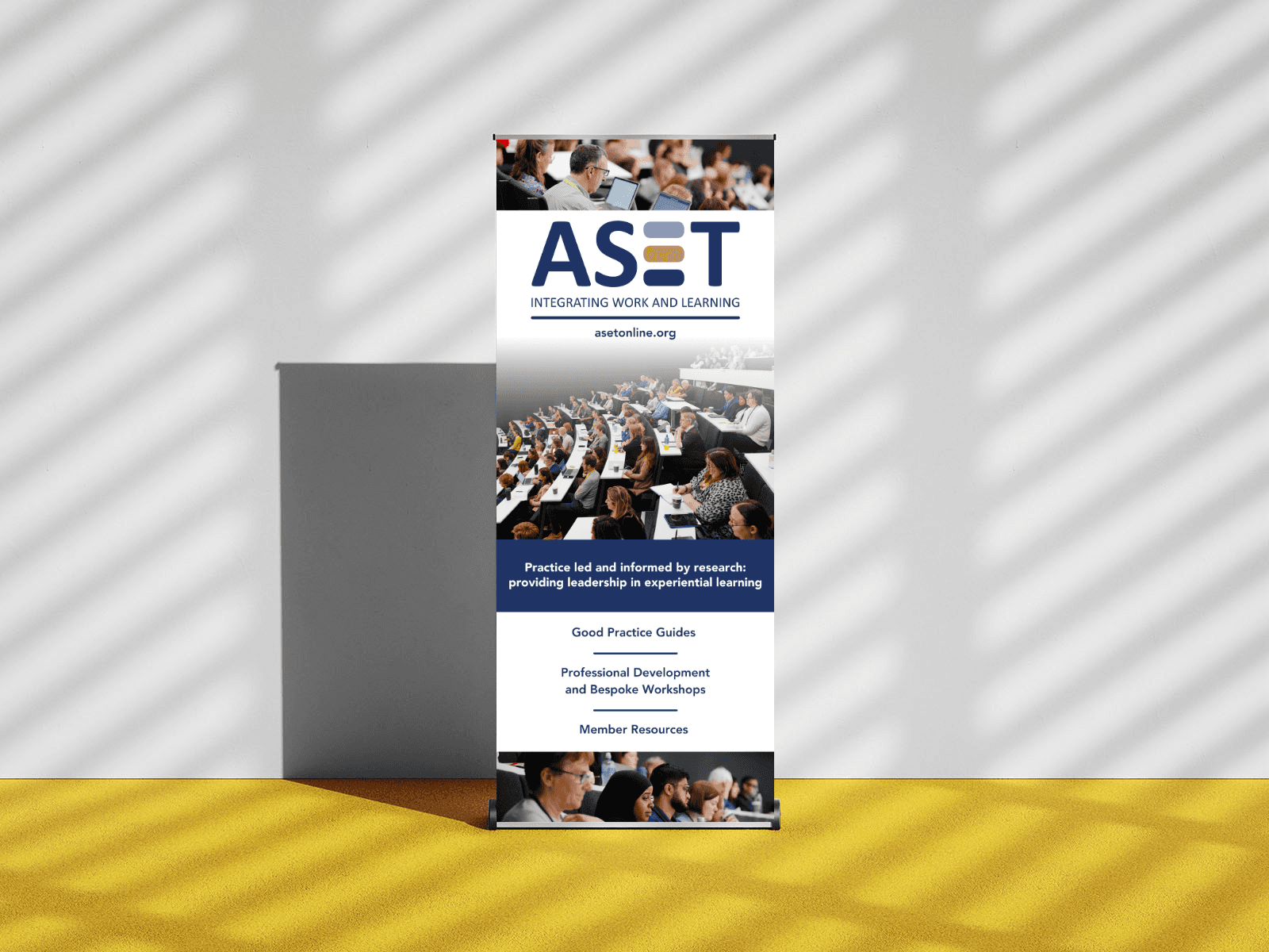 Mock up image of a pull up banner featuring multiple images of audiences in a lecture theatre.