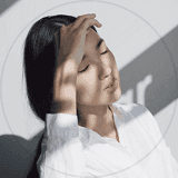 A woman with her hands on her head, accompanied by the text "The Power of the Mind."