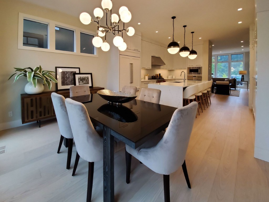 Image of Modern dining area with kitchen and layout design by KHD Homes featuring furniture and interior design.