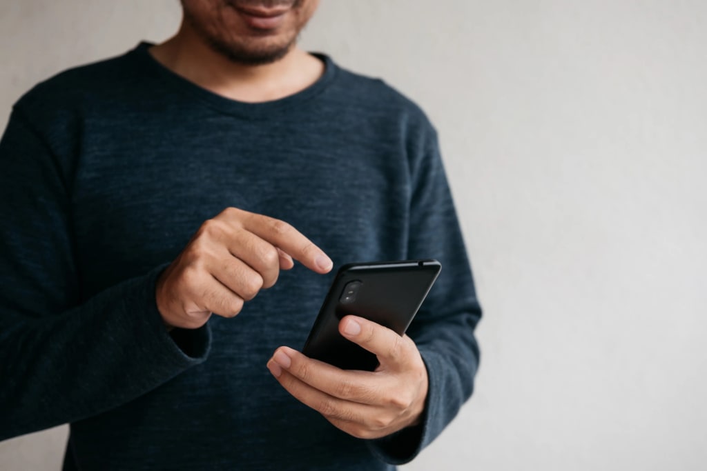 Best apps for landlords to collect rent illustrated by a person using a smartphone to manage rental payments.