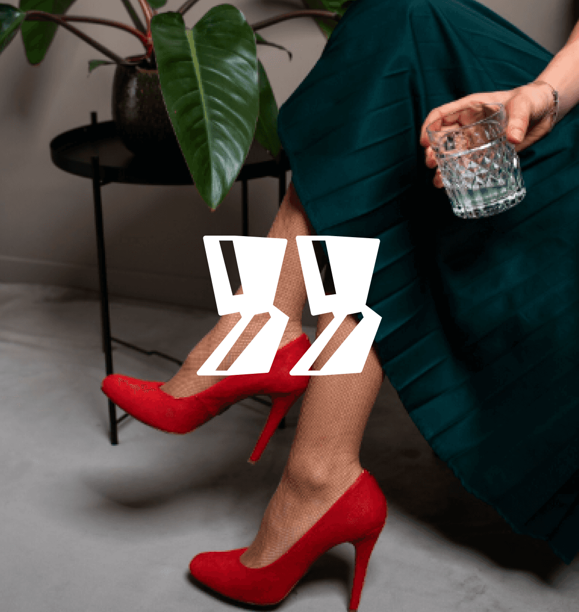 Modern home office setup with a monitor, ergonomic chair, keyboard, and indoor plants near a window with blinds.