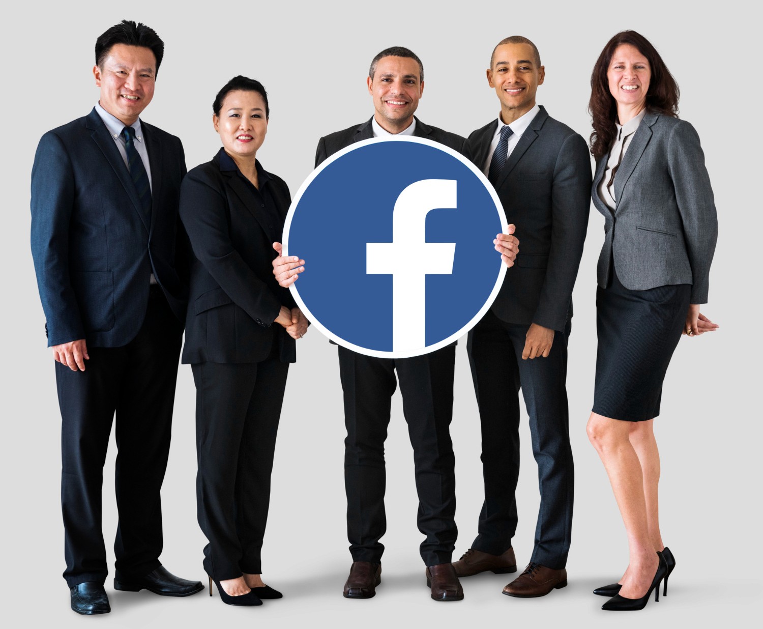  A diverse group of business professionals proudly displaying a Facebook sign in a collaborative setting.