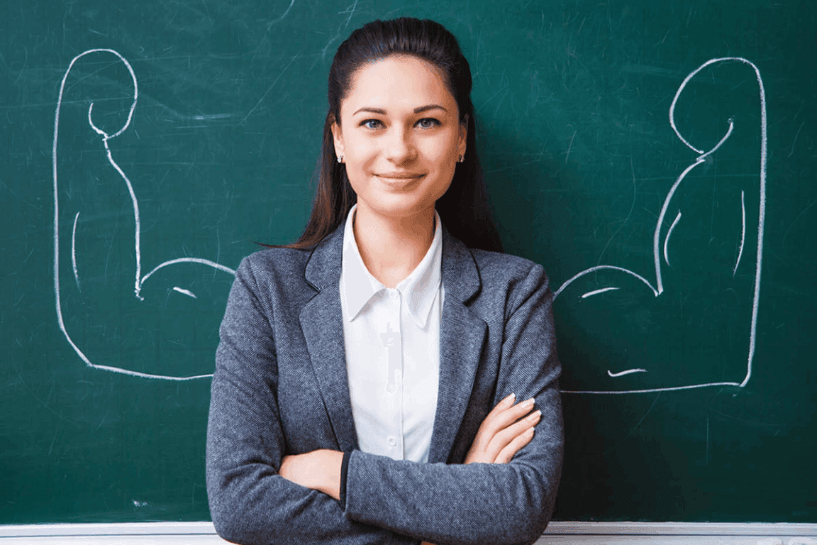 Professional adult standing confidently in business attire, representing educators.