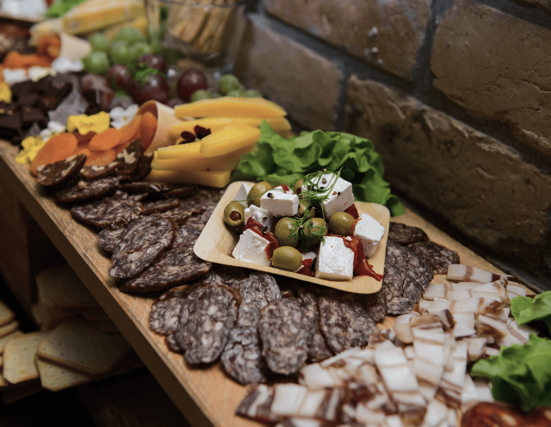  A rustic charcuterie board loaded with sliced cured meats