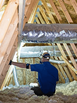 A diverse team collaborates around a table, analyzing documents and charts in a professional setting with a light green background.