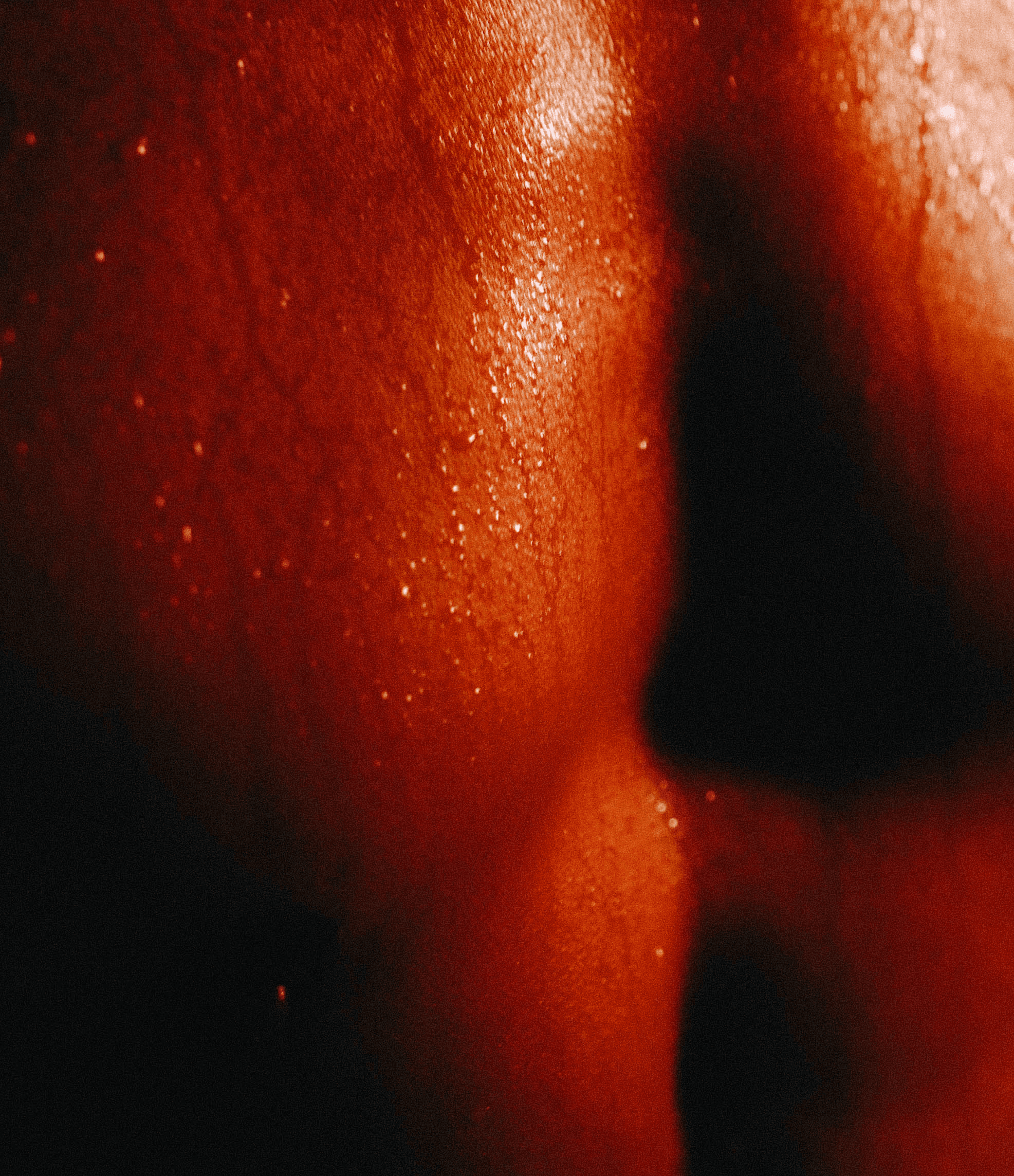 Close-up of warm, sweat-flushed skin showing the body's heat response during a traditional sauna session