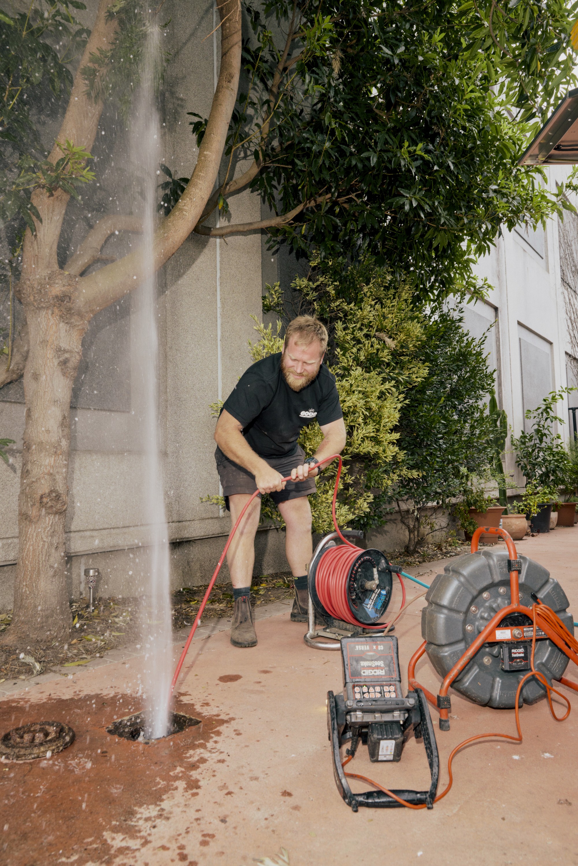 Good Maintenance Plumber uvblocking an outdoor drain at a residential property