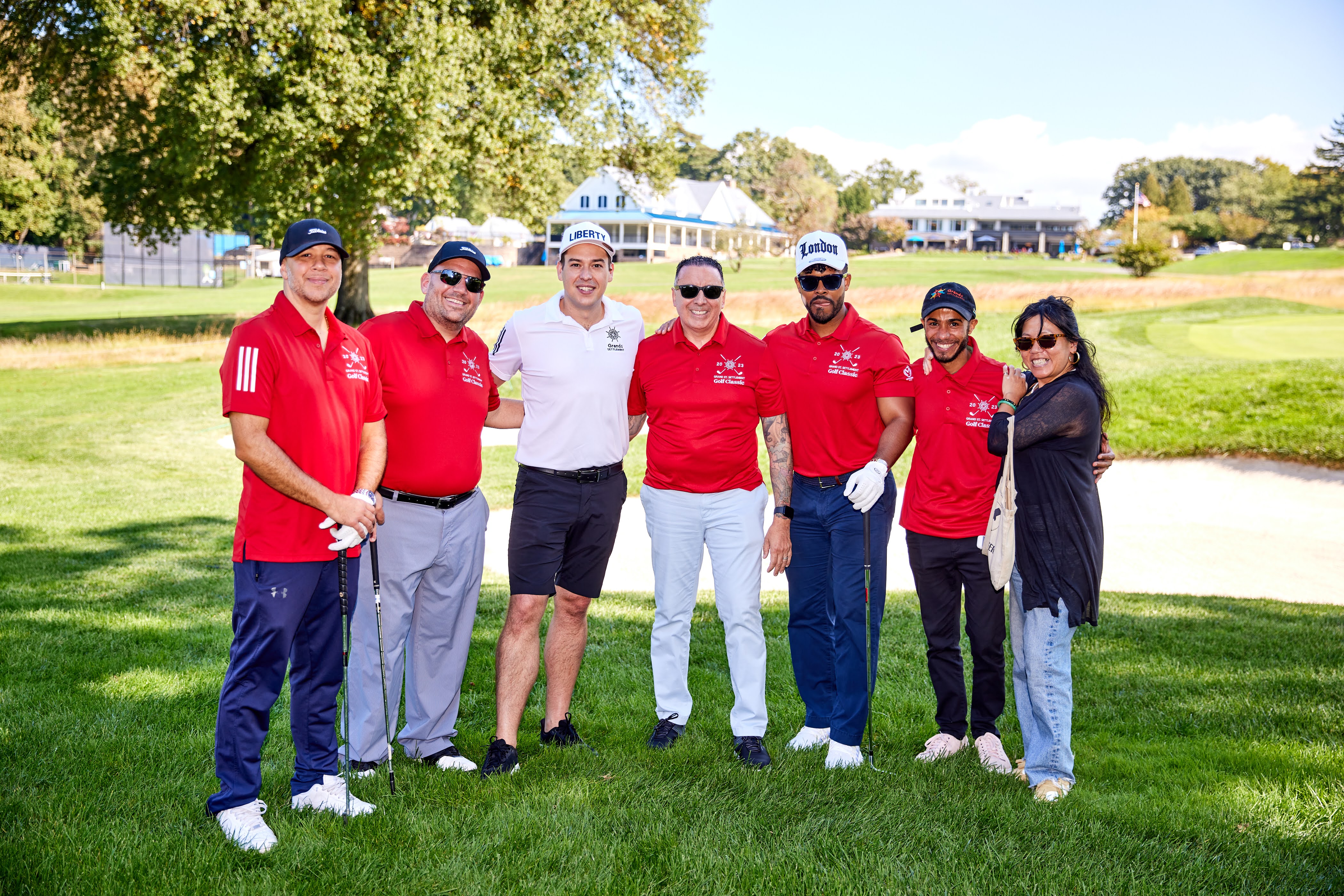 A group of people pose for a photo on a golf course