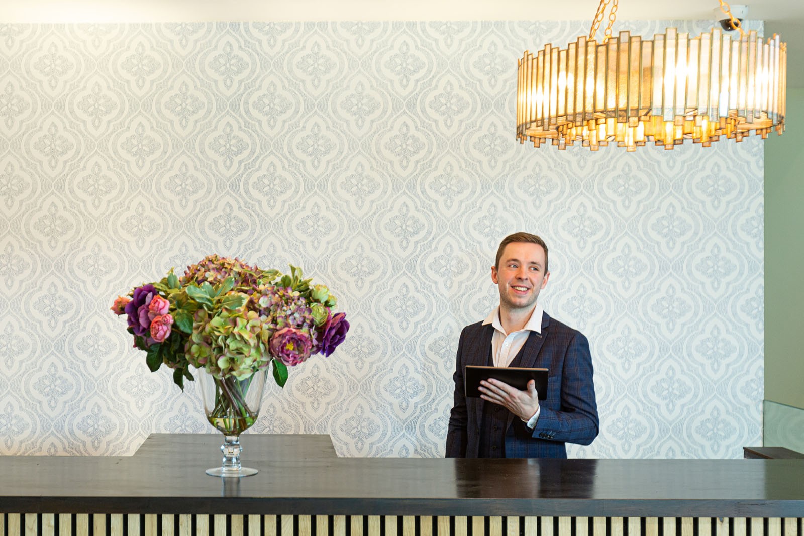 A Hotel reception with a male staff memeber