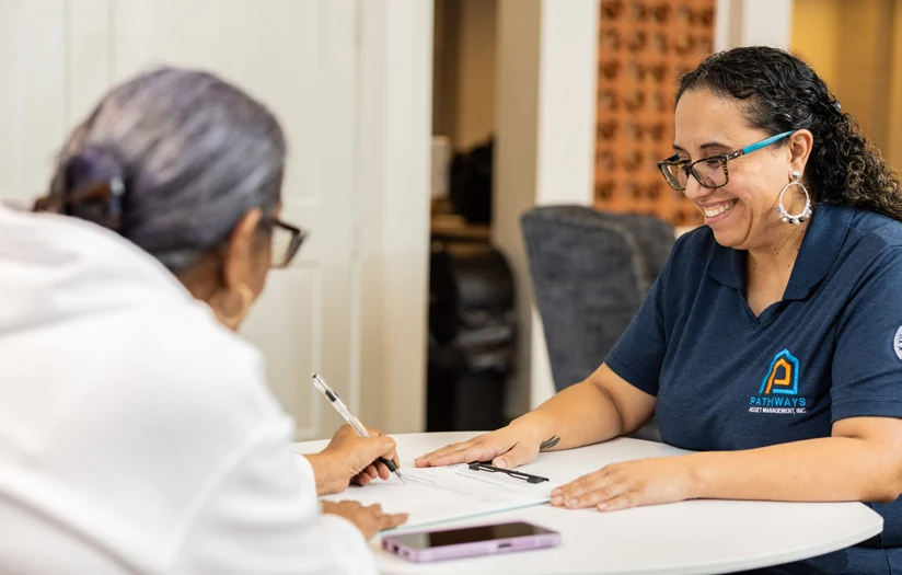An AHA staff member meeting with a resident