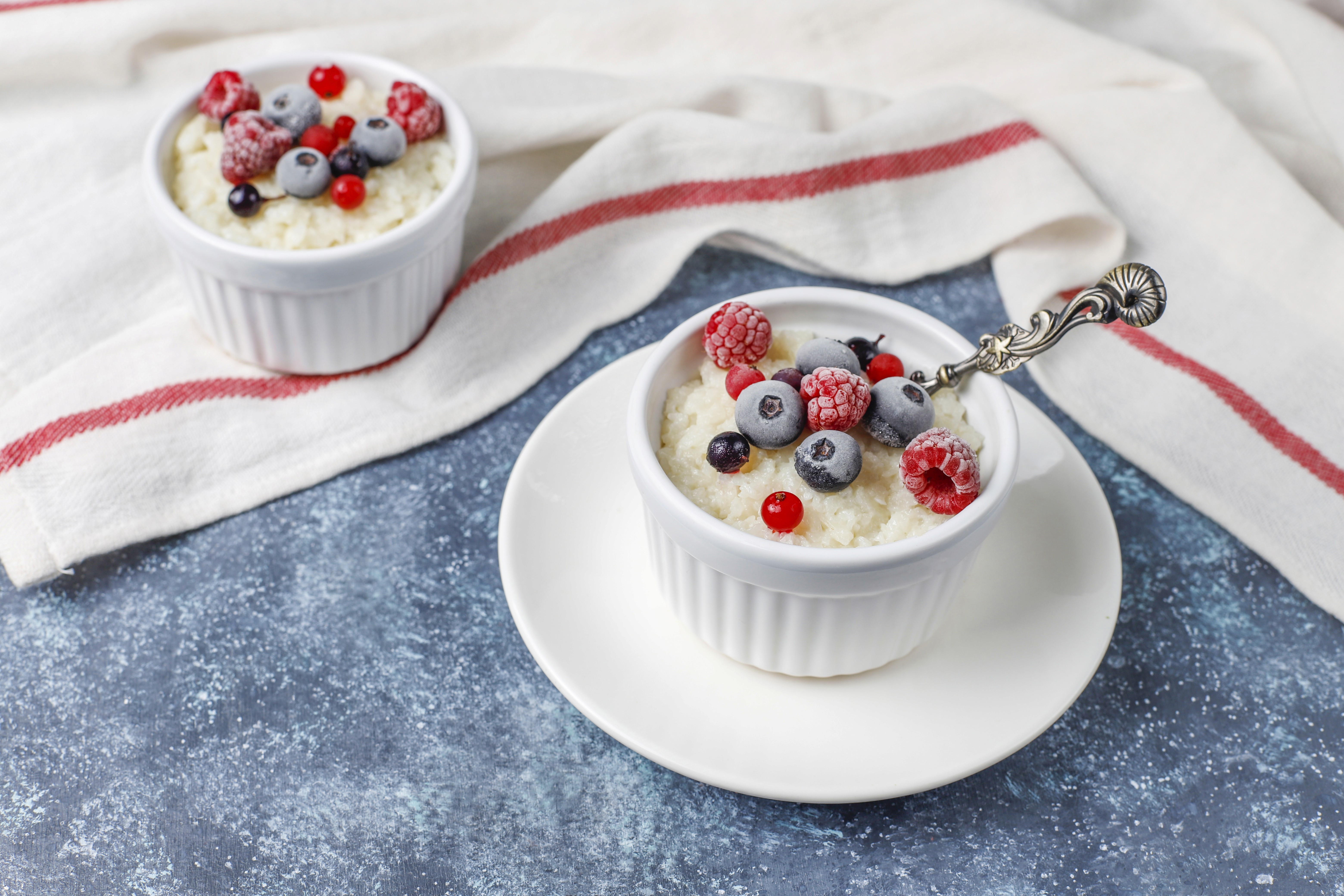 Bowl of non-fat Greek yogurt topped with fresh blueberries and strawberries
