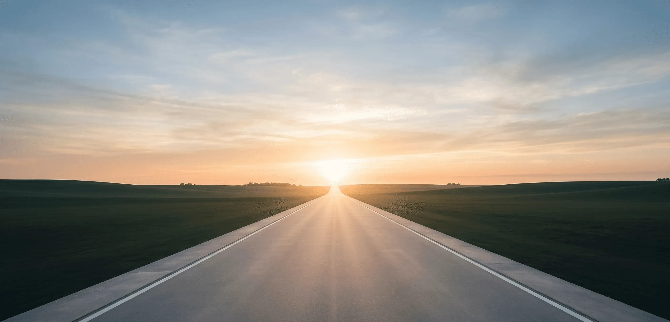 long straight road or pathway leading toward a bright horizon