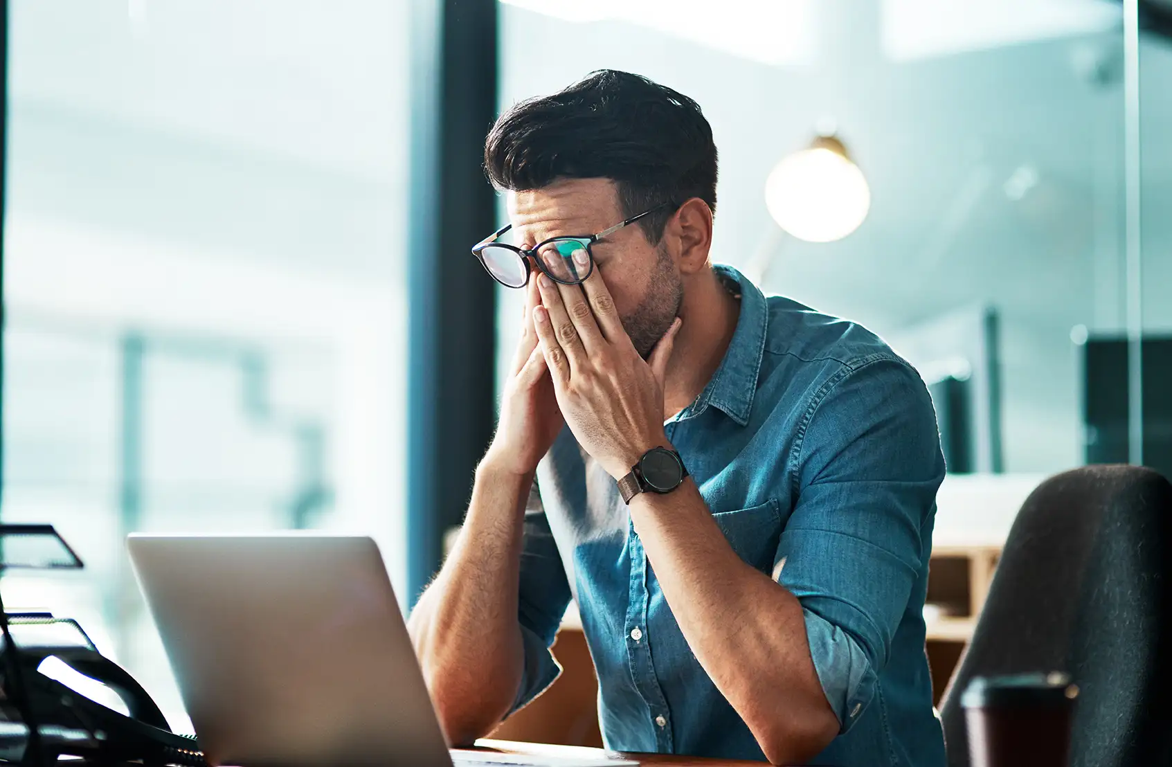 Frustrated startup founder sitting in front of a laptop