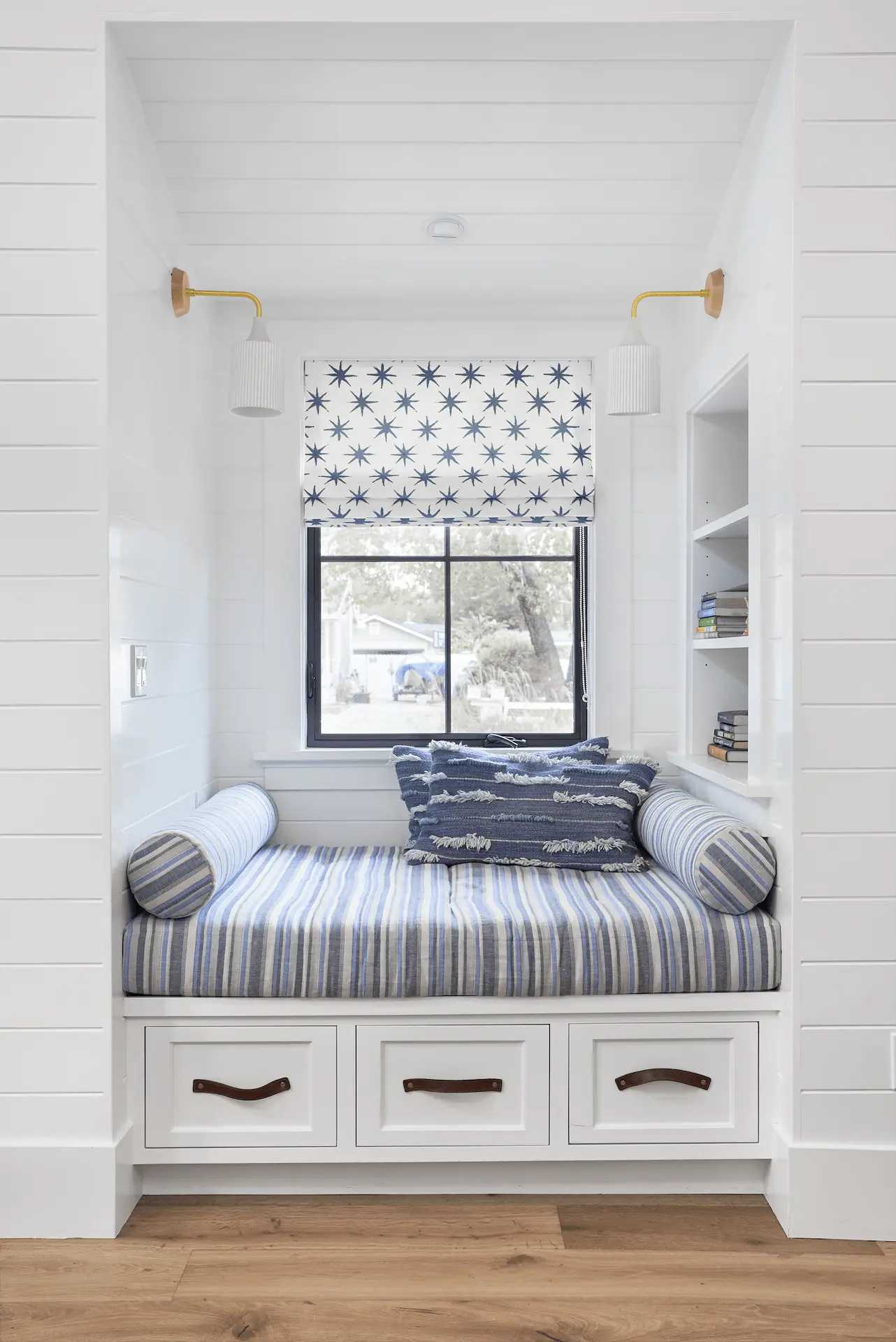 Cozy reading nook with cushioned bench and storage in North Tustin Remodel & Addition. Photo by Todd Huge.