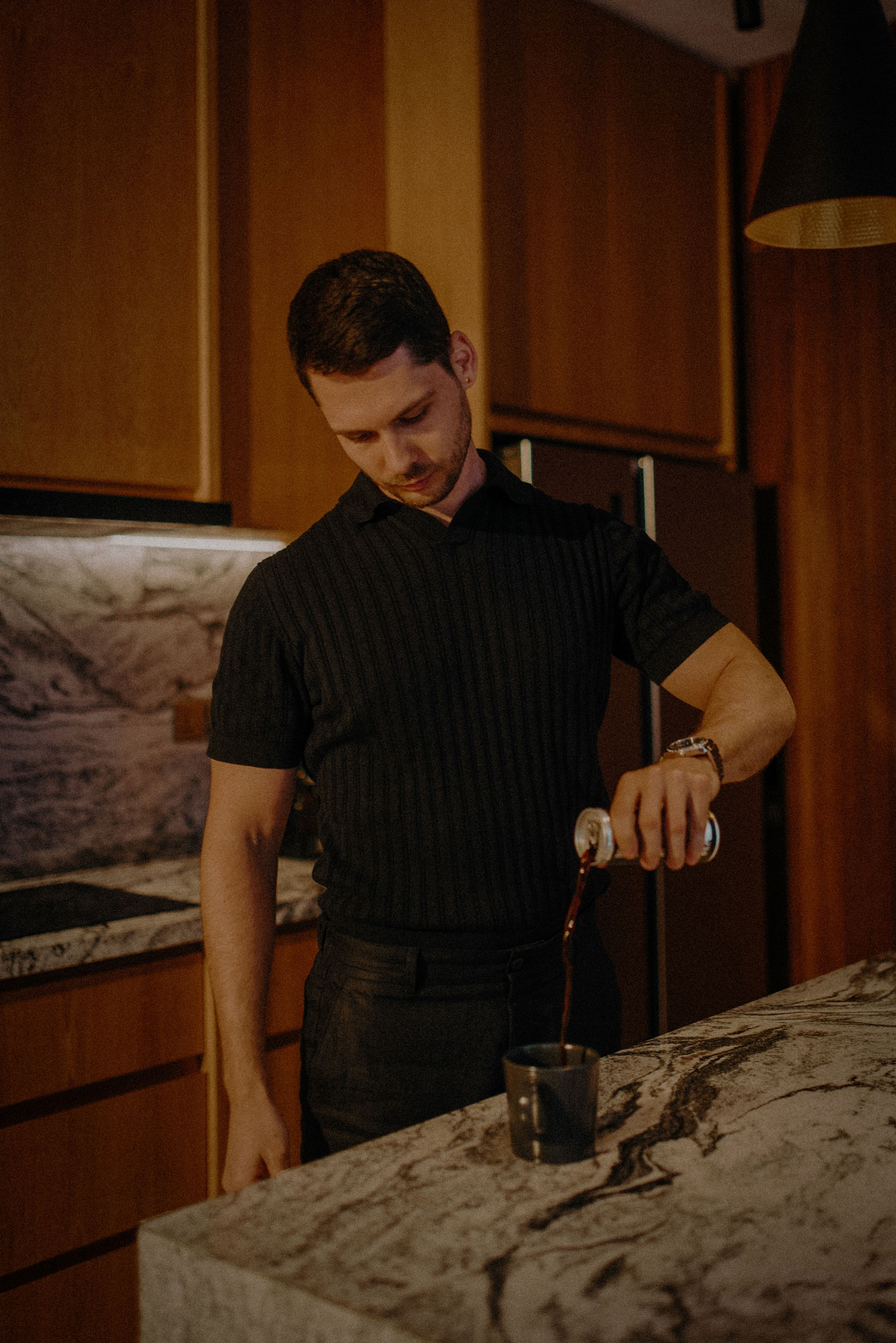 A diverse team collaborates around a table, analyzing documents and charts in a professional setting with a light green background.