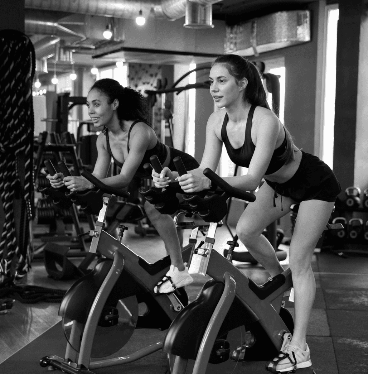 women doing indoor cycling workout in gym