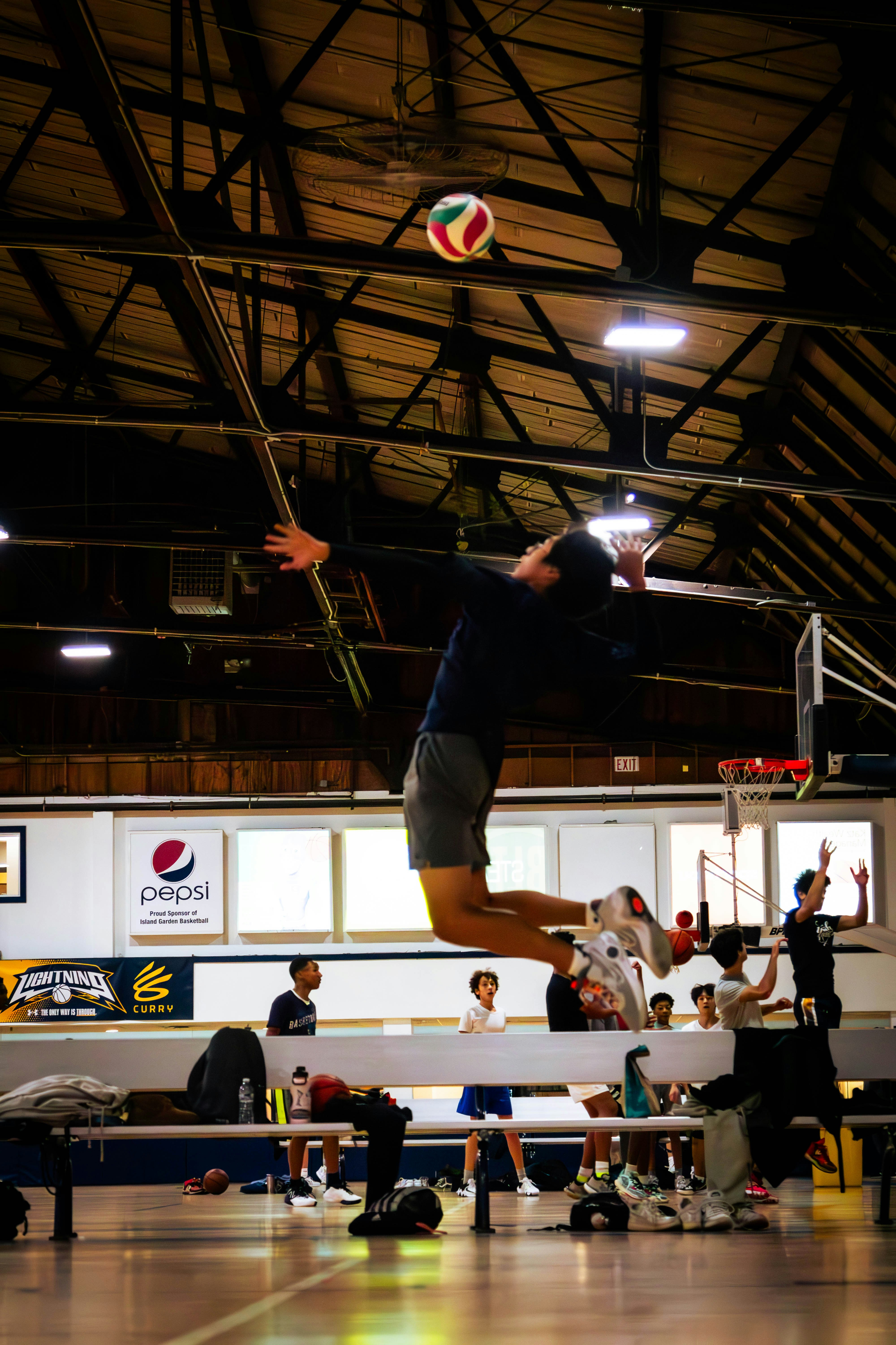 a man jumping in the air to hit a volleyball
