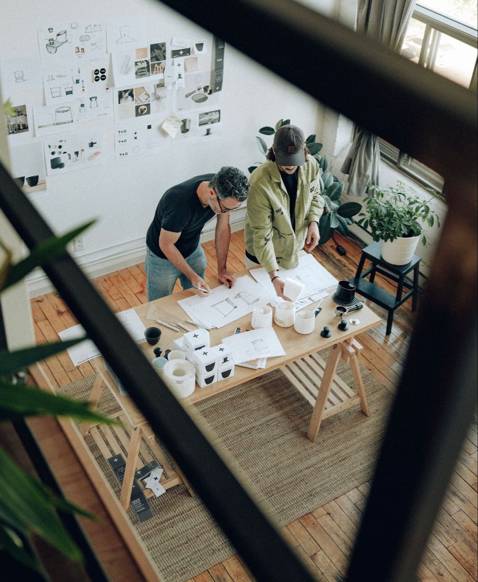Creative workspace with large windows and a wall full of inspiration boards.