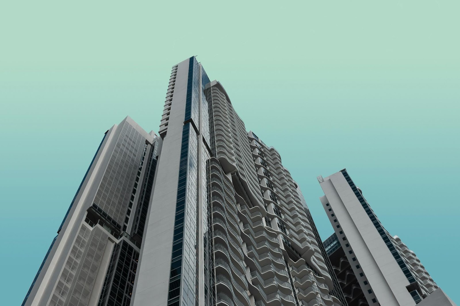 Commercial real estate skyscraper on a blue-green sky background