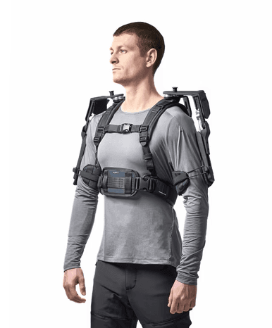 Close view of a person wearing the DeltaSuit exoskeleton, designed to support the shoulders and arms during repetitive tasks at height.