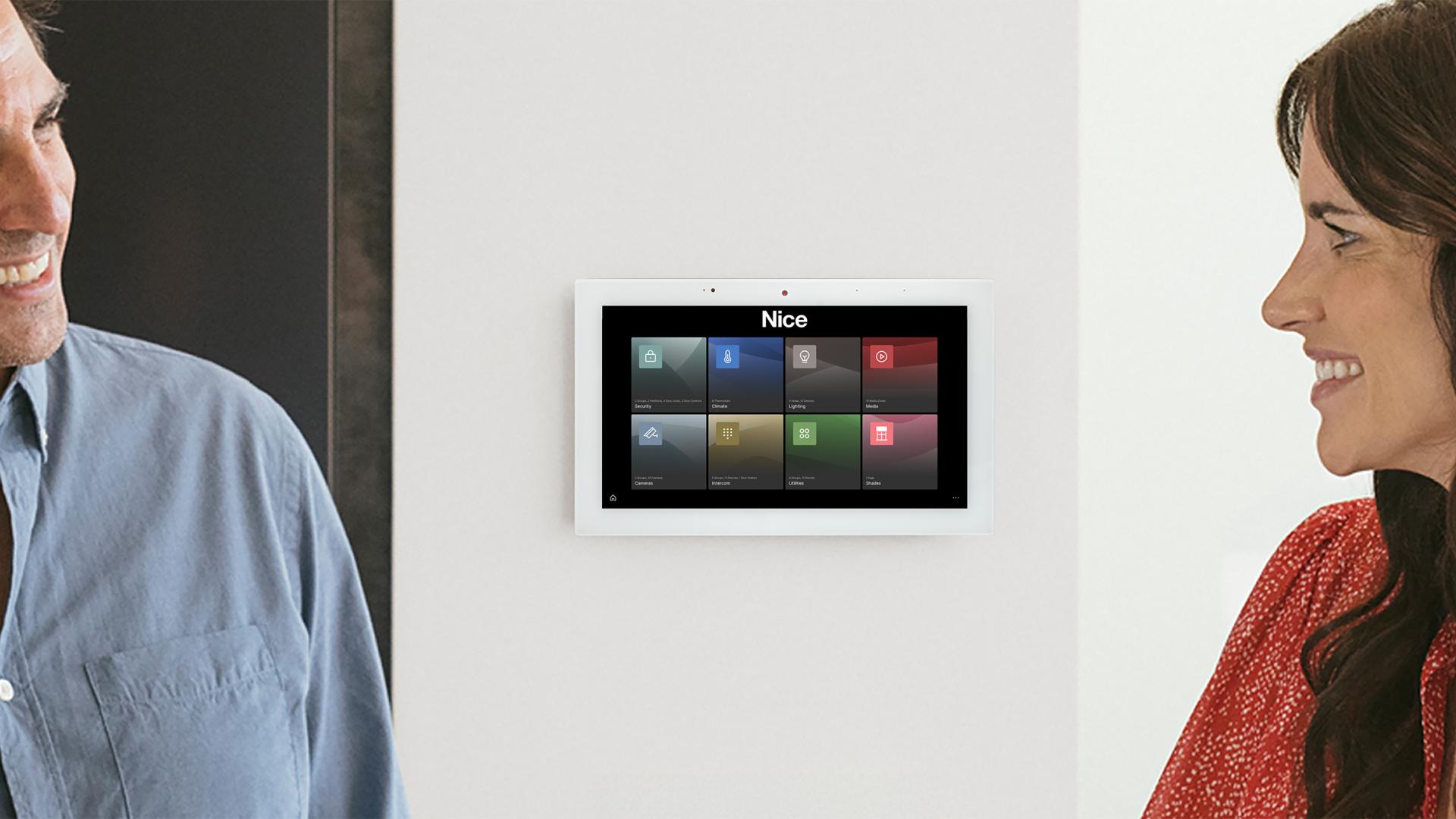 Wall-mounted Nice tablet with home automation icons.