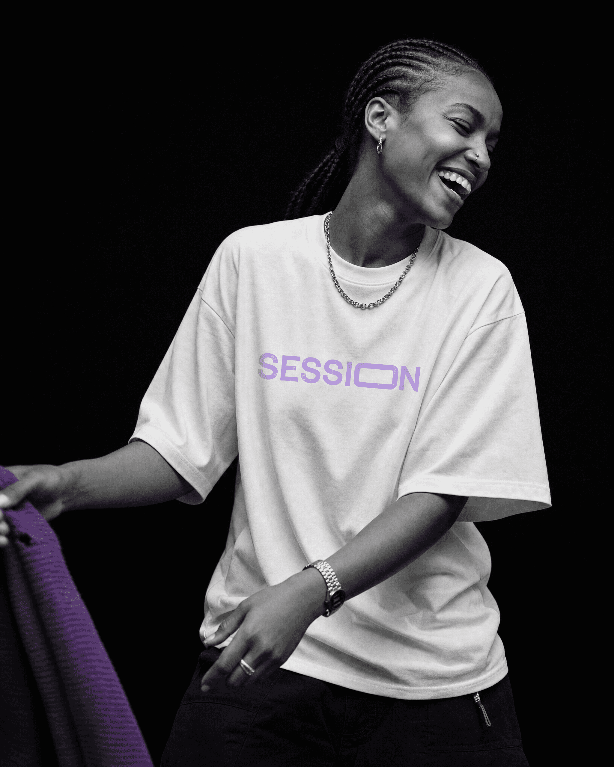 Woman laughing in a white Session Zone T-shirt with a light-purple SESSION logo.