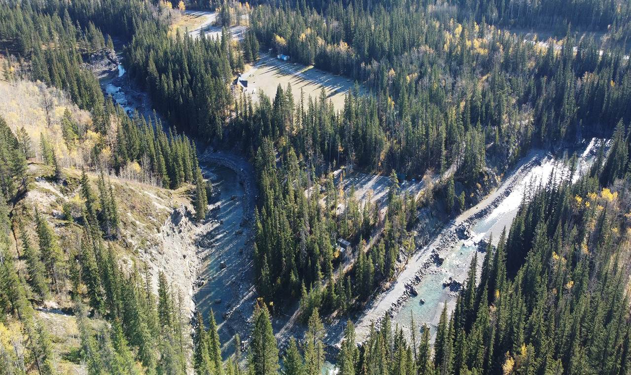 Aerial view of Canoe Meadows campground with accessible water access pathway along river in Kananaskis