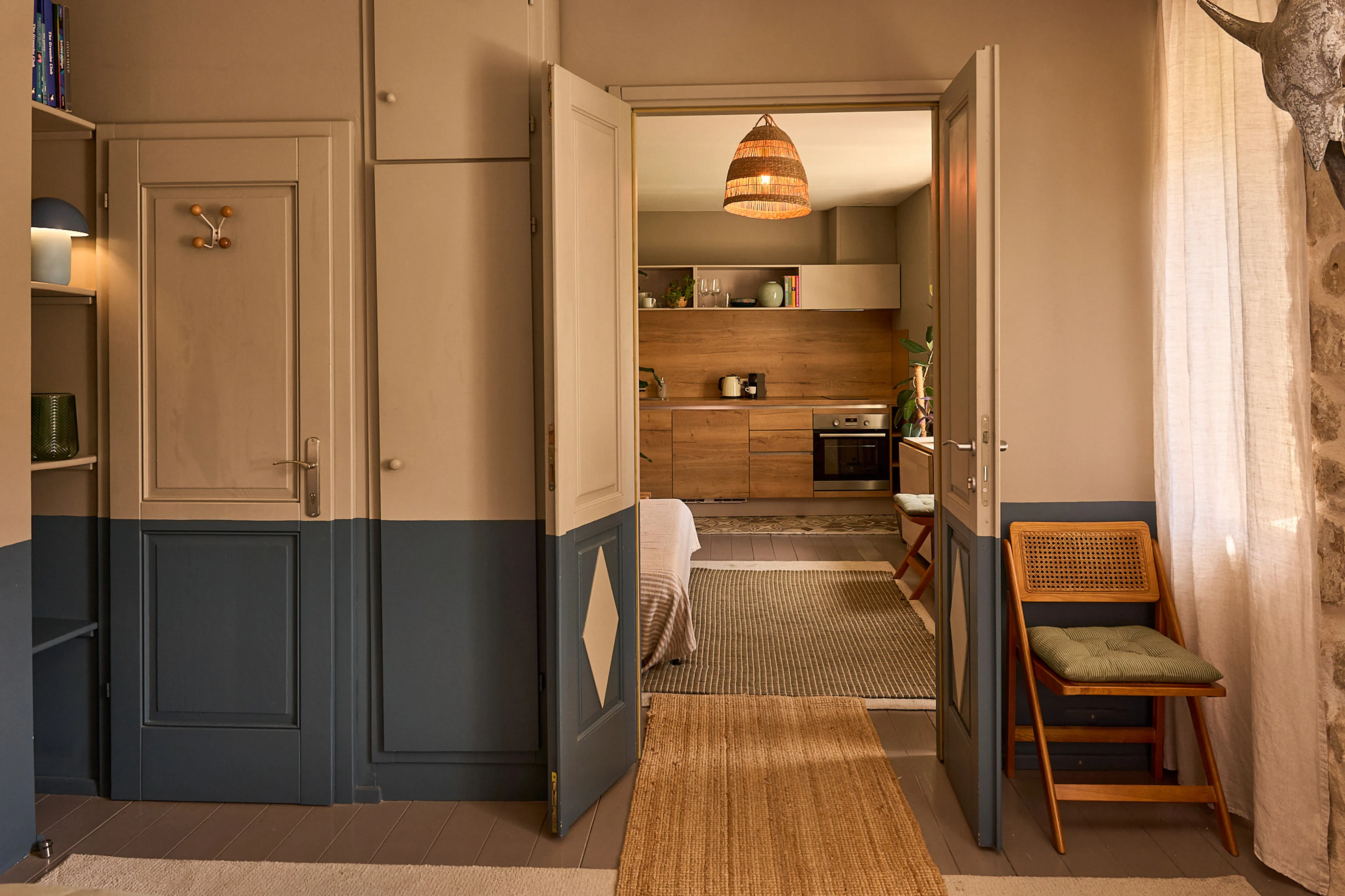 Open double doors connecting the bedroom and kitchen in the Silvija Suite, Hidden House, Stari Grad