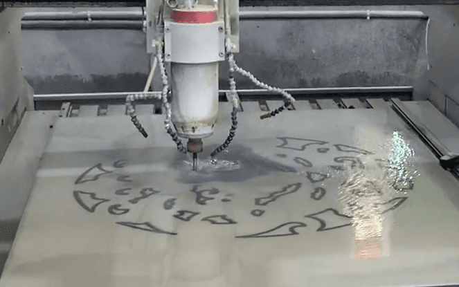 A CNC engraving machine creating a circular design on stone, demonstrating high precision and clean engraving techniques.