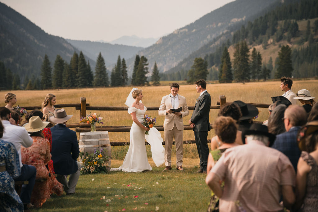 Outdoor wedding ceremony framed by mountain views