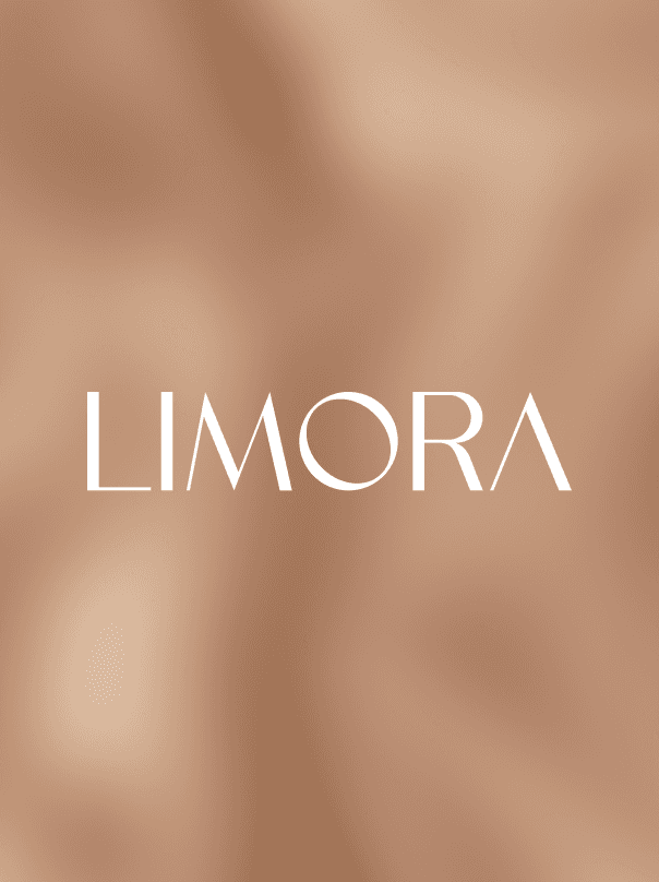 A woman with short curly hair wearing a black t-shirt looks into the camera.