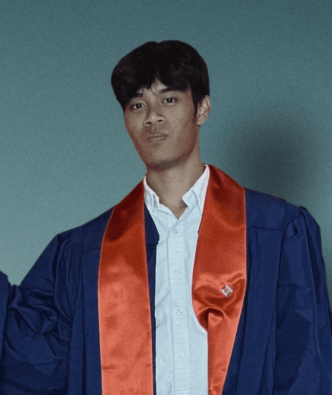 A confident person with short, styled hair and a leather jacket poses against a dark backdrop.