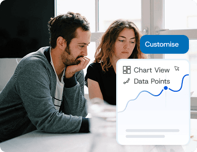 Two professionals reviewing financial data on a laptop with a “Customise” overlay and live analytics graph, symbolising tailored reporting and insights.