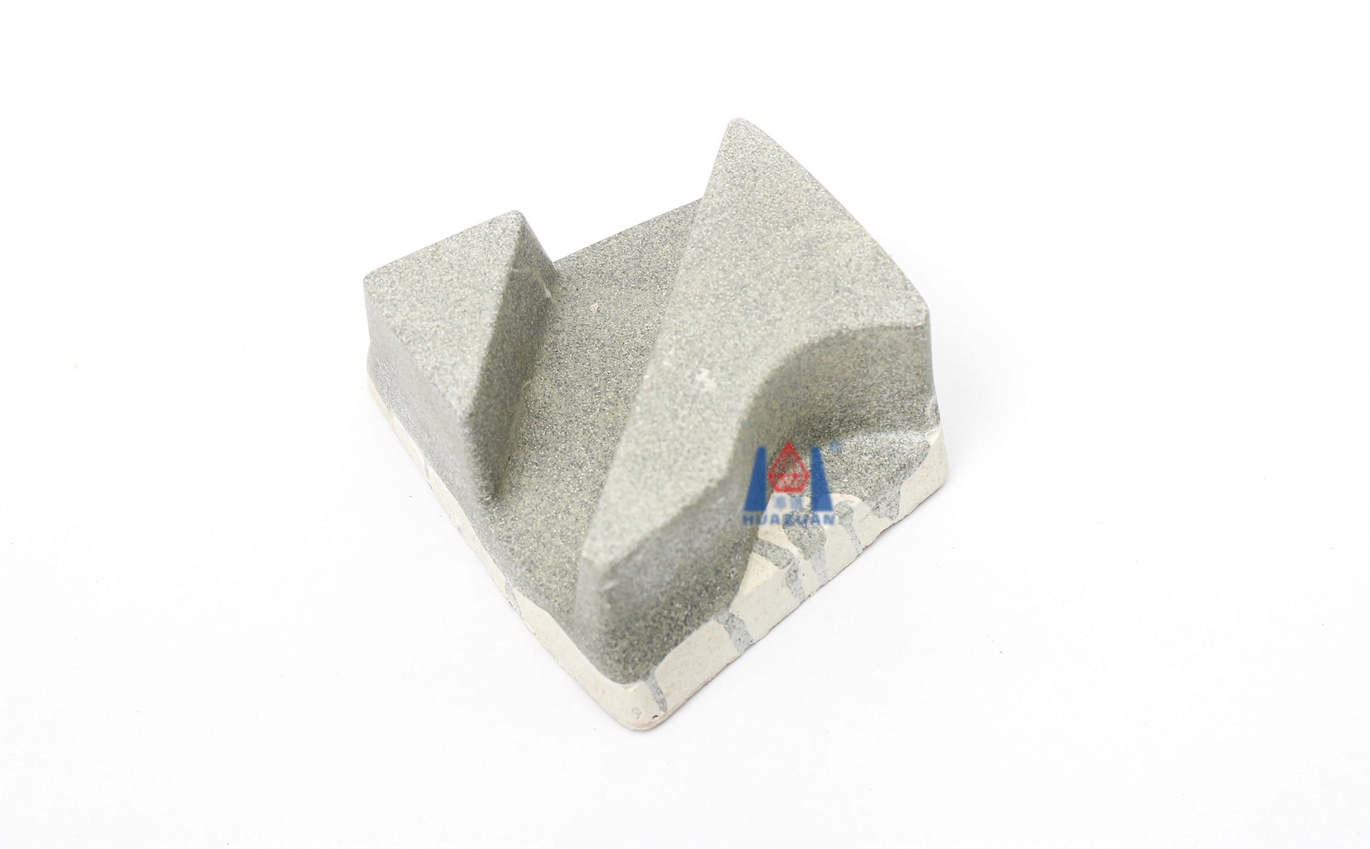 A single resin bond diamond fickert, positioned flat, displaying the intricate design and texture on its surface.