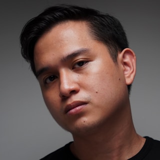 Business professional profile portrait: a man in a black shirt is posing for a picture