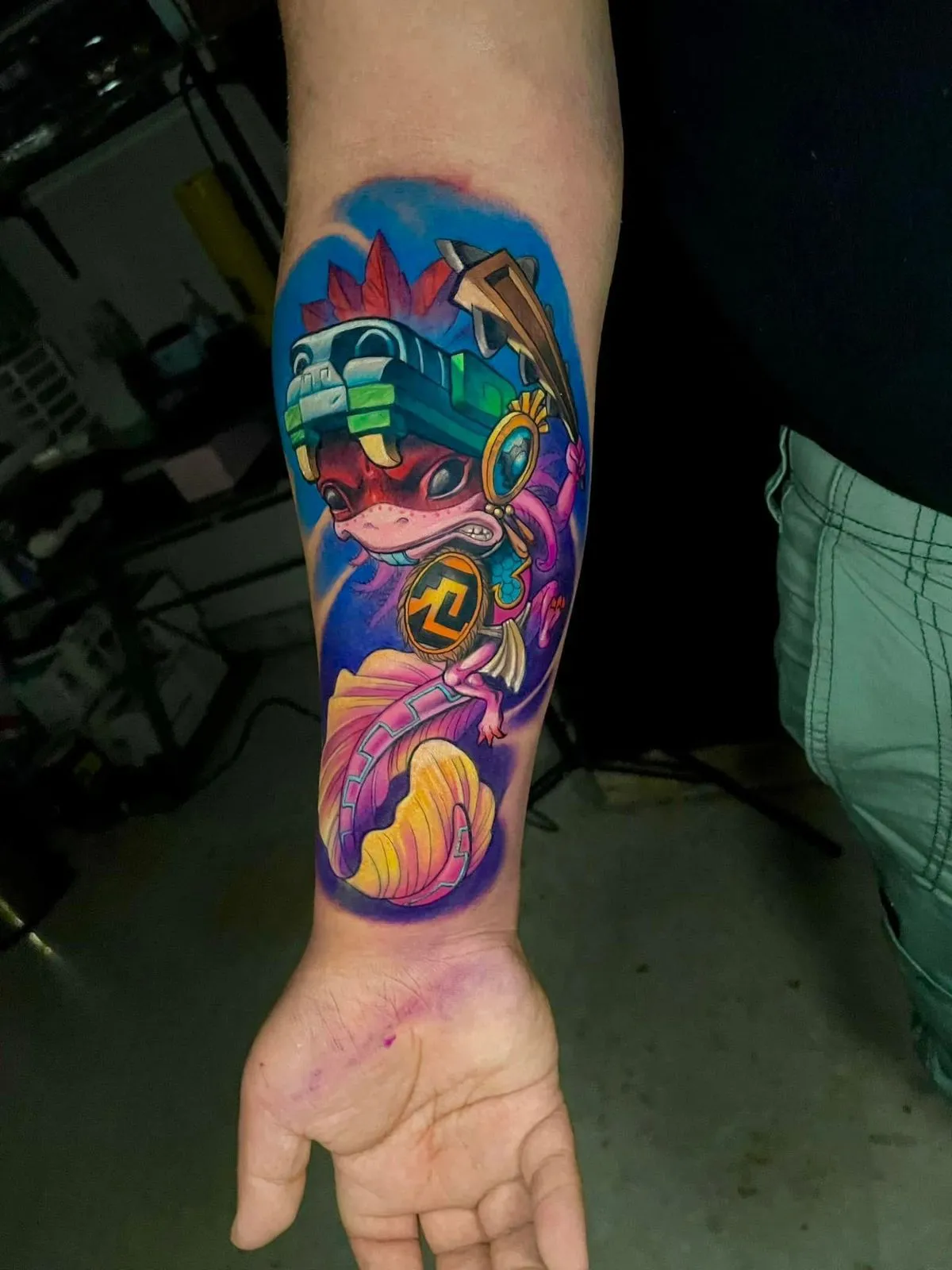 Color anime creature tattoo on forearm with vibrant fantasy design at Calavera Ink Berlin
