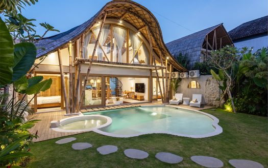 Luxury villa with pool at night. Professional real estate agent services for elite Kerobokan rentals and sales.