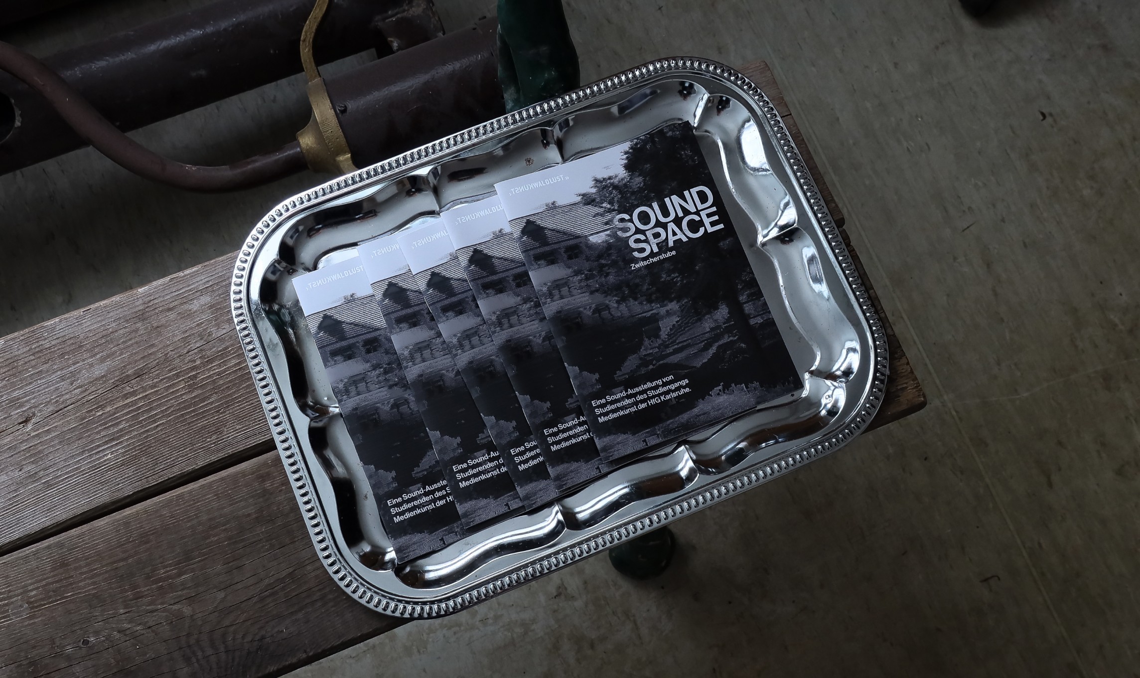 Stack of modern books and magazine with minimalist cover design on leather chair