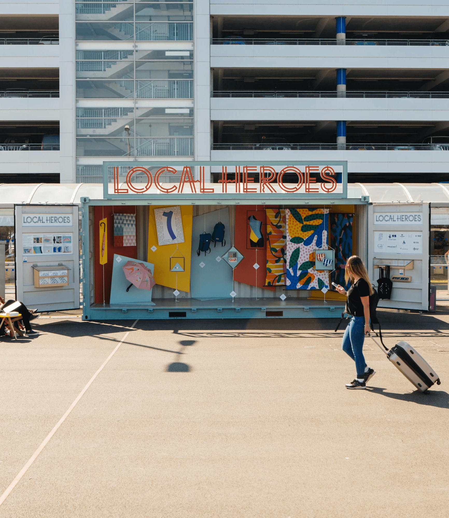 Pop up exhibition design in a converted shipping container, including a CNC cut sign as part of the sculptural installation