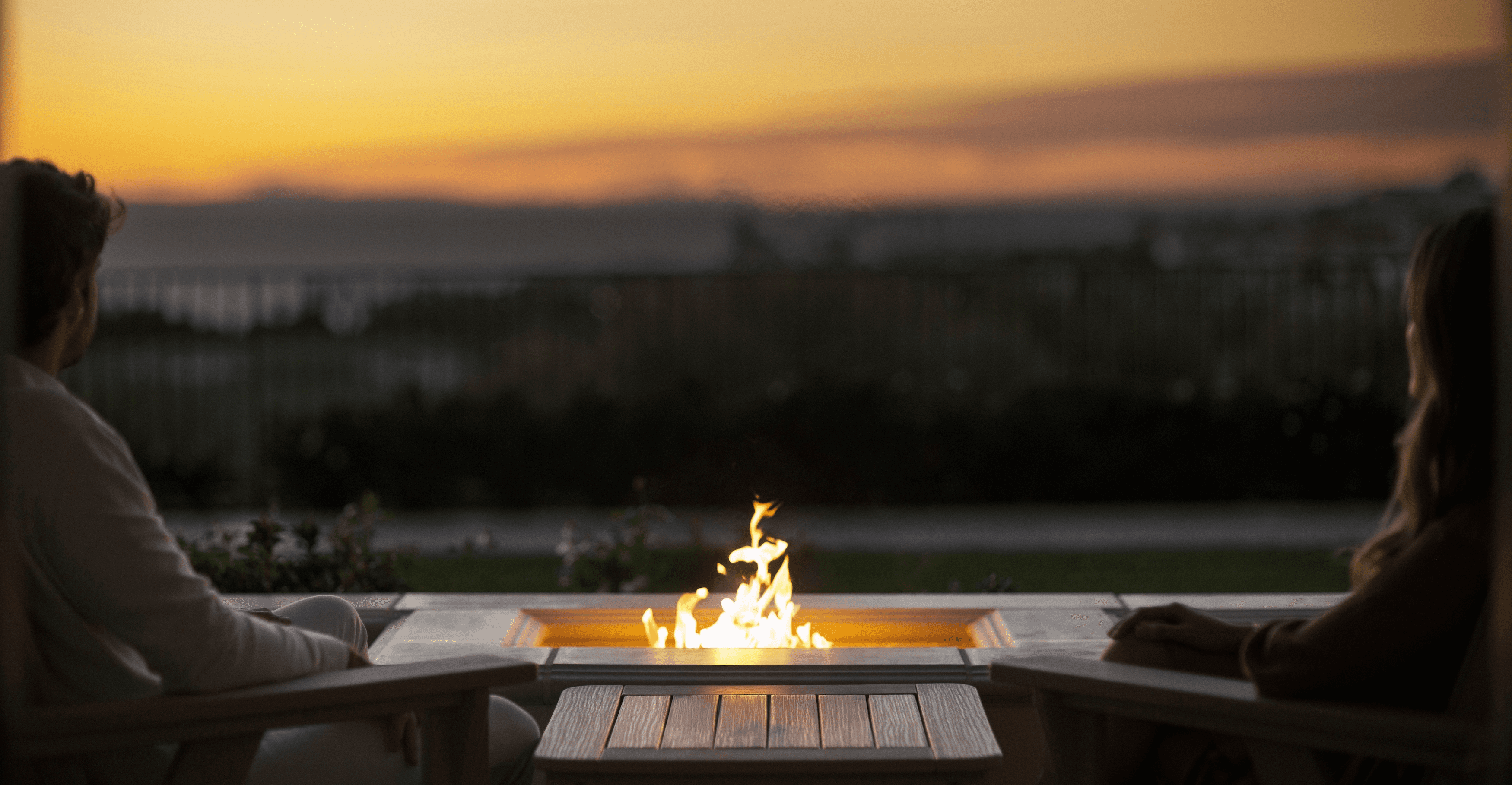 woman holding a phone and man looking at the phone. both are smiling