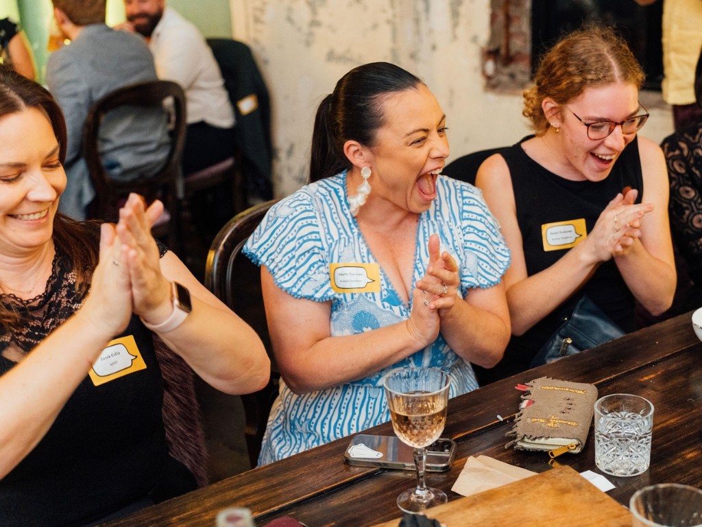 Teams at a Banana Life event cheering at a correct answer