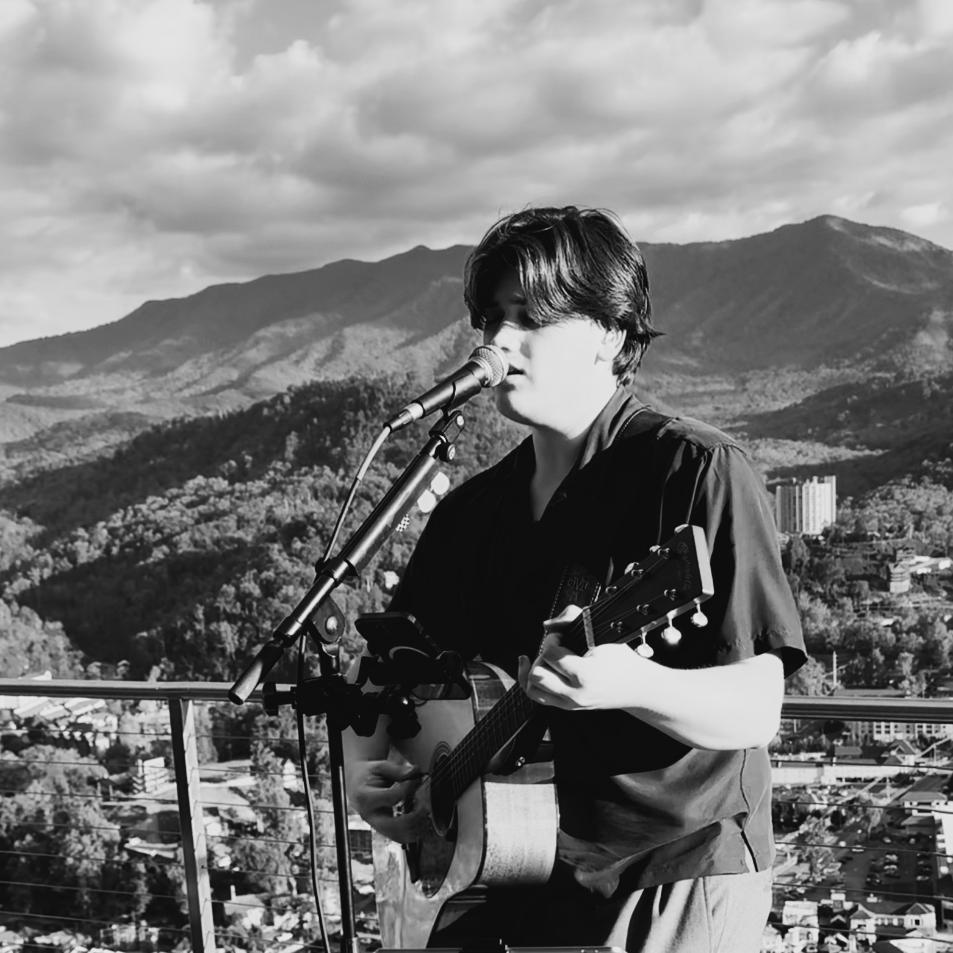 Guitarist performing on stage in silhouette